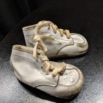 Image of a pair of baby shoes from St. Louis exhibit